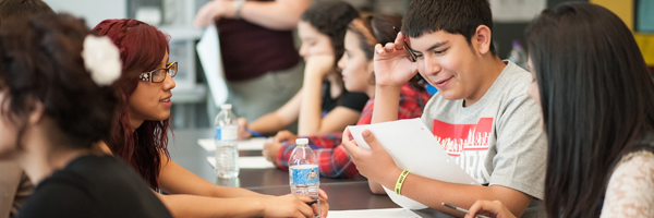 Two Facing History students discuss a paper during a Bullying Summit